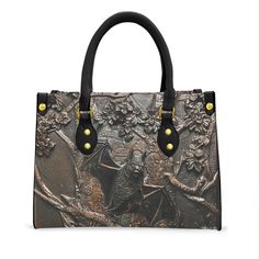 Step back in time with our exquisite Victorian-inspired handbag. Crafted from rich tooled leather, this handbag exudes elegance and charm reminiscent of a bygone era.  This spectacular vegan leather handbag features a printed image from a tooled Victorian mourning bag. The bag itself is smooth, not tooled.  This distinctive handbag is custom made after your order, taking 5-9 days in production (in addition to the shipping time of 10-20 days.) Regular shipping is included in the purchase price. If you need yours sooner, an upgrade to 5-10 days express shipping for an additional $40 is available. Goth Victorian, Vegan Leather Handbag, Bygone Era, Top Handle Bags, Tooled Leather, Step Back, Leather Tooling, Back In Time, Leather Handbag