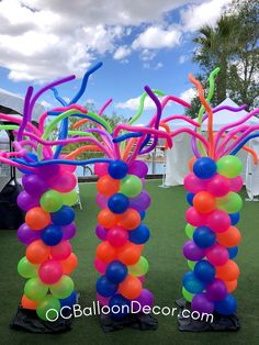 balloons and streamers are arranged in the shape of trees