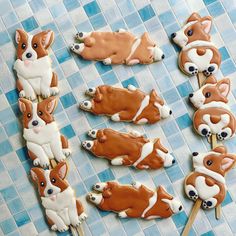 there are many cookies shaped like corgis on the table with toothpicks