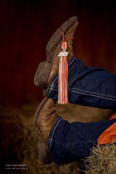 a cowboy's boot with a tassel hanging from it