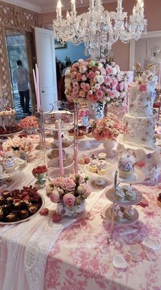 a table topped with lots of cakes and cupcakes