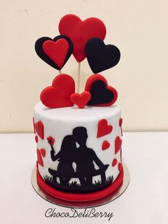 a cake decorated with red and black hearts