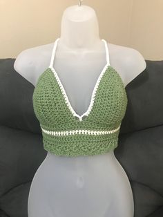 **Top will automatically come with white color trim unless you specifically pick a different color for it** -Hand crocheted crop top perfect for the warm summer months at the beach, or at any festival.  -Made with I Love This Cotton Yarn -The size of this top works best for someone who is 'Medium C cup' -Adjustable corset style tie in the back and a tie around the neck  -Hand wash with cold water and white vinegar to help set the color in place. Color will fade over time.  *Top will slightly shrink after the first wash* Summer Cotton Halter Top With Crochet Trim, Crochet Trim Triangle Top For Beach Season, Triangle Top With Crochet Trim For Beach Season, Festival Crochet Trim Triangle Top, Cropped Crochet Top With Crochet Trim For Summer, Green Triangle Crop Top For Summer, Green Cotton Crochet Top For Vacation, White Crochet Crop Top For Beach, Festival Triangle Top With Crochet Trim