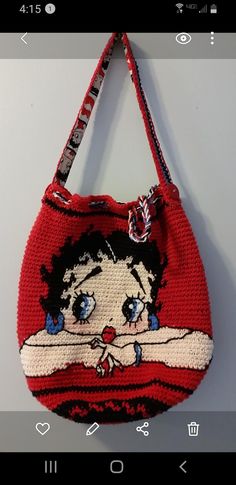 a red purse with an image of a woman on it