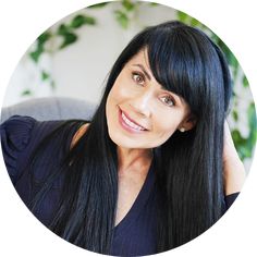 a woman with long black hair smiling at the camera