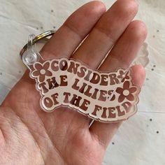 a hand holding a keychain that says, consider the life of the field