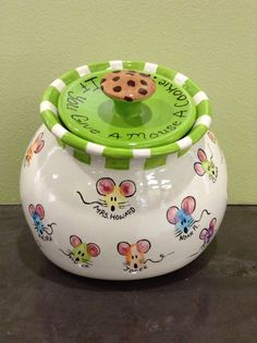 a ceramic container with a cookie on it