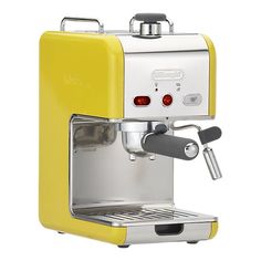 an espresso machine sitting on top of a white counter next to a yellow box