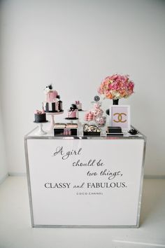 a white counter topped with cakes and flowers