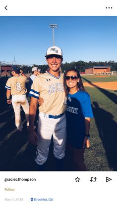 a man and woman are posing for a photo at a baseball game on facebook,