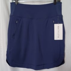 Athleta Women's Navy Blue Fairway Golf Skort 18" Two Front Pockets With Zipper Closure. Hidden Waist Band Pocket. Drawstring Waist Round Bottom. Nwt. Measurements Approximate. Waist 15" Relax Top To Bottom 19" Body. 74% Nylon, 26% Spandex. Lining. 81% Polyester, 19% Spandex. Mesh. 87% Nylon, 13% Spandex. Army Green Skirt, Athleta Shorts, Juicy Couture Charms, Gray Camo, Tennis Skort, Rayon Pants, Golf Skort, Linen Skirt, Distressed Black Jeans