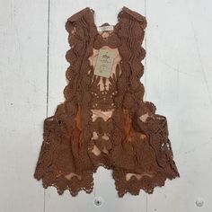 Lush Womens Brown Lace vest Size Small. New condition See pics LS180/22i5BH30 Sleeveless Brown Sweater Vest For Summer, Spring Brown Sleeveless Sweater Vest, Sleeveless Brown Sweater Vest For Spring, Brown Sleeveless Sweater Vest For Spring, Vintage Sleeveless Tank Top For Fall, Fall Festival Sleeveless Tank Top, Beach Vest Tops For Fall, Vintage Tank Vest For Spring, Fall Beach Sweater Vest Sleeveless