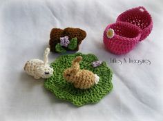 three crocheted animals sitting on top of green grass