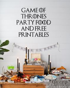 the game of thrones party food and free printables is displayed on a table