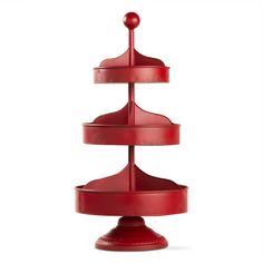 a red three tiered cake stand on a white background