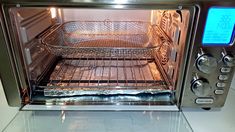 an open toaster oven sitting on top of a counter