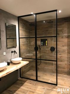 a bathroom with a sink, mirror and shower in it's center area is shown