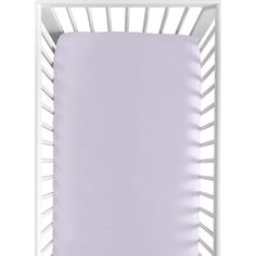 a white crib with a purple sheet on it