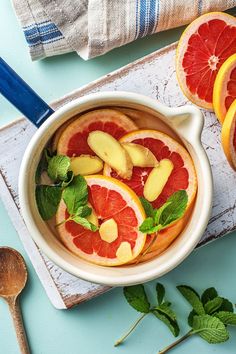 a bowl filled with sliced grapefruit and oranges