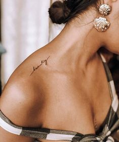 a woman with a small tattoo on her back