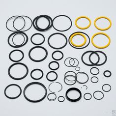 various types of rubber o - rings on a white surface with black and yellow trims