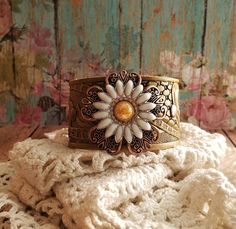 v'¯) .`*.¸.*' ❤ CONCHO COLLECTION ❤ ¸.*'.*'¨) ¸. (¸.*'(¸.*' (¸. My leather concho cuff bracelets will add a rustic feminine touch to your look! Each made from tooled leathers & beautifully detailed conchos. Filigrees and rivets add dimension. They can be dressed up or down to compliment any outfit. Buy it ---- Wear It----Make it your own! This DESIGN~ ❤ A pretty yellow and white daisy is layered over a beautiful copper flower filigree. ❤ Set on hand painted yellow tooled leather. A dark wash Flowers Wild, Daisy Jewelry, Daisy Bracelet, Pretty Yellow, Concho Belt, Stamped Bracelet, Field Of Flowers, Yellow Daisy, Jewelry Flower