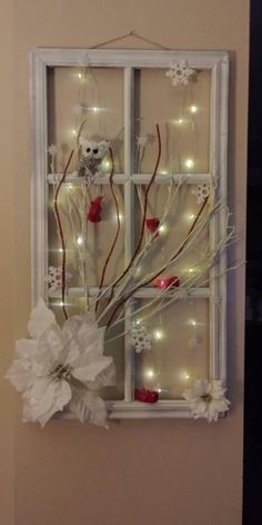 a window decorated with white flowers and lights