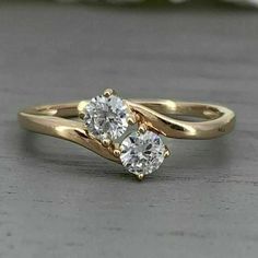 two diamond engagement rings sitting on top of each other