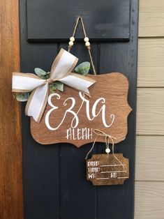 a wooden sign hanging on the side of a door with a name tag attached to it