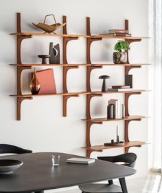 a wooden shelf with books and vases on it