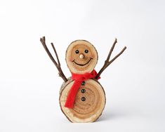 a small wooden snowman with a red bow on it's head