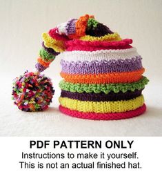 a multicolored knitted hat with a pom - pom attached to it