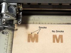 an image of the letter m being printed on a piece of paper with a ruler