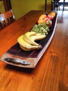 a wooden table topped with lots of different types of fruit