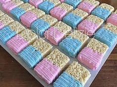 there is a cake made to look like rice krispy treats on a tray with pink and blue frosting