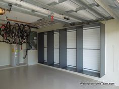 an empty garage with several bikes hanging from the ceiling