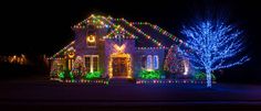 a house covered in christmas lights at night