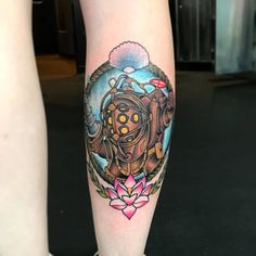 a tattoo on the leg of a person with a gas mask and flowers in front of them