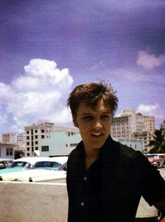 a young man holding a skateboard in his hand