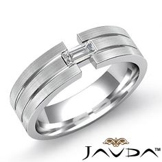 a white gold wedding ring with a cross on the side and a diamond in the center