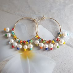 Rainbow earrings, colorful earrings, beach jewelry, big hoop earrings, modern jewelry, mothers day gift, freshwater pearl hoop earrings, wire wrapped earrings, cute earrings, summer jewelry, unique earrings, rainbow jewelry, 24K gold filled hoop. Modern trendy beach jewelry. These rainbow earrings look like a piece you might pick up on vacation. Wear them with everything from a T-shirt and jeans to your favorite swimsuit. HIGH QUALITY MATERIALS / SIZE 24-karat gold filled 20mm hoops wire wrapped Rainbow Earrings For Beach And Summer, Rainbow Drop Earrings For The Beach, Handmade Rainbow Earrings For The Beach, Colorful Hoop Earrings For The Beach, Rainbow Drop Earrings For Beach, Colorful Dangle Hoop Earrings For Summer, Colorful Handmade Hoop Earrings For Beach, Beach Hoop Earrings Wire Wrapped, Colorful Drop Earrings For Beach