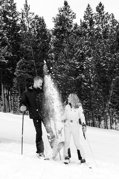 Black and white photo. Engaged couple on skis throws snow into the air. Breckenridge Ski Resort, Apres Ski Outfits, Colorado Ski