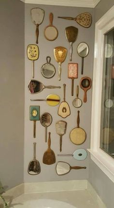 there are many spoons and spatulas on the wall