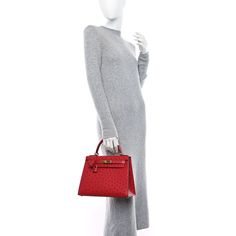 This is an authentic HERMES Ostrich Kelly Sellier 28 in Rouge Casaque. This popular tote is crafted of ostrich leather in red. The shoulder bag features a top handle, a detachable shoulder strap, a flap with a strap closure, gold plated hardware including a kelly turn lock, a covered padlock, and a key clochette. The flap opens to a matching leather interior with pockets. Hermes Ostrich, Kelly Sellier, Ostrich Leather, Leather Interior, Top Handle, Shoulder Strap, Gold Plate, Key, Shoulder Bag