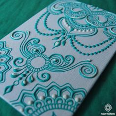 an intricately designed card on a green background