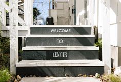 a set of stairs with the words welcome to lenoir painted on them in black and white