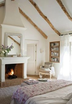 a bedroom with a fireplace and white walls