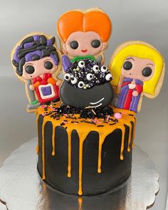 a halloween cake with three little kids on top