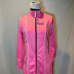 a pink nike jacket with white piping and zippers