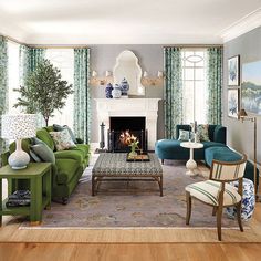 a living room filled with furniture and a fire place next to a window covered in curtains